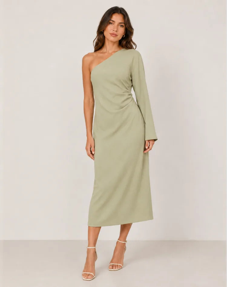 Front view of model wearing a sage green one-shoulder maxi dress with long bell sleeve and ruched waist detail