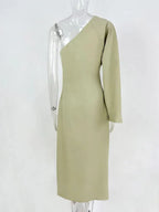 Three-quarter back view of the sage green dress on a mannequin showing the clean seam lines and fitted waist