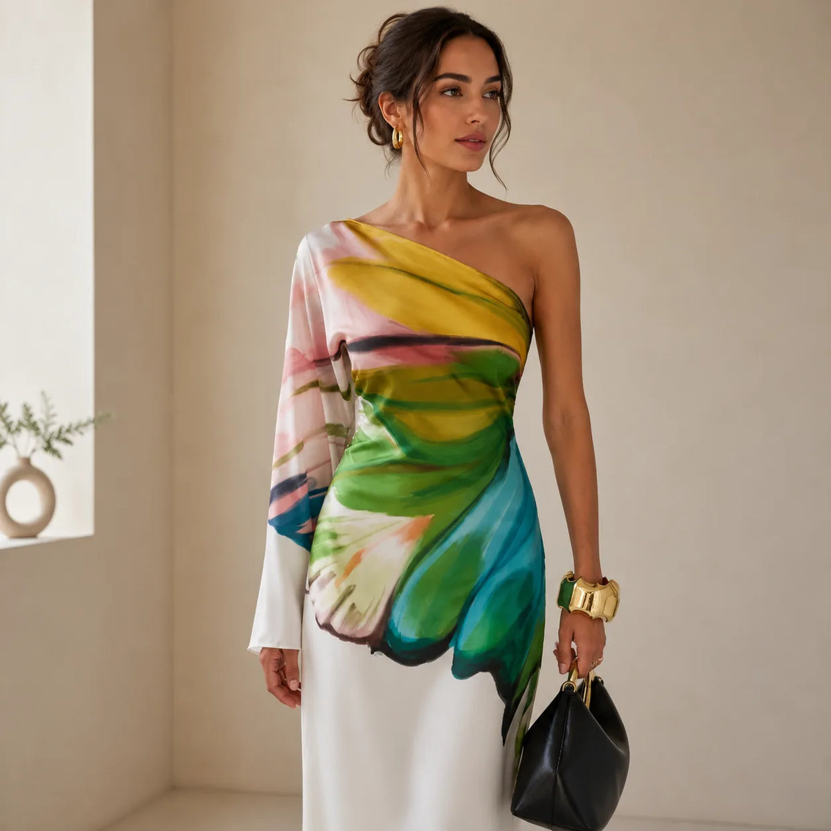 Close-up side angle highlighting the vivid yellow, green, blue and pink painterly print and the long draped sleeve against the white A-line fabric.