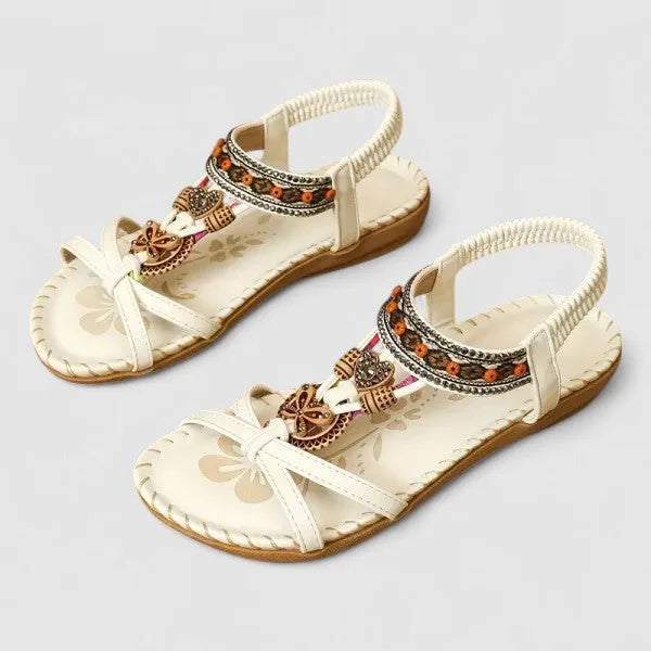 Close-up side view of black sandals highlighting the beaded strap and flexible flat sole