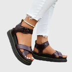 Side view of a burgundy faux-leather sandal with crisscross toe straps, ankle buckle and chunky platform sole