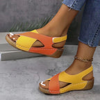 Front angle of yellow and orange wedge sandals highlighting the cushioned stitched footbed