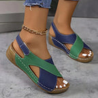 Side angle of navy and green colour-block wedge sandal showing the cut-out ankle strap design