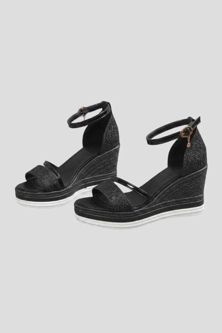 Black glitter wedge sandals with ankle strap, open toe and woven espadrille-style platform sole, side angle
