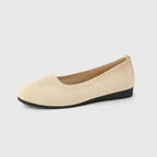 Side view of a cream knit ballet flat with square toe and black wedge sole on a plain background