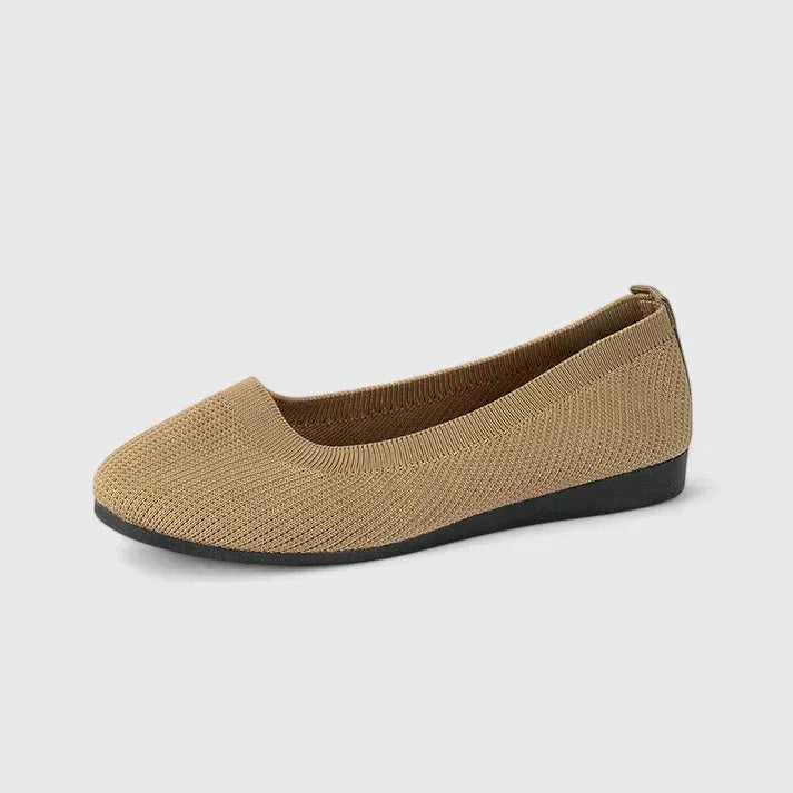 Side profile of a khaki knit ballet flat highlighting the ribbed texture and low wedge heel