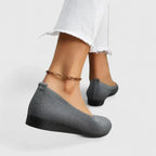 Close-up side view of a chocolate brown knit ballet flat showing the stretch knit upper and black sole