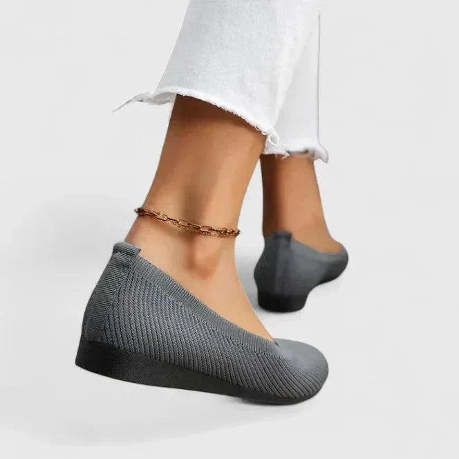 Close-up side view of a chocolate brown knit ballet flat showing the stretch knit upper and black sole