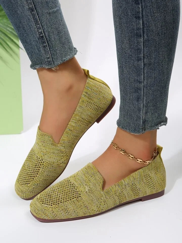 Mustard yellow knit loafers with square toe, worn with cropped denim and a gold chain anklet