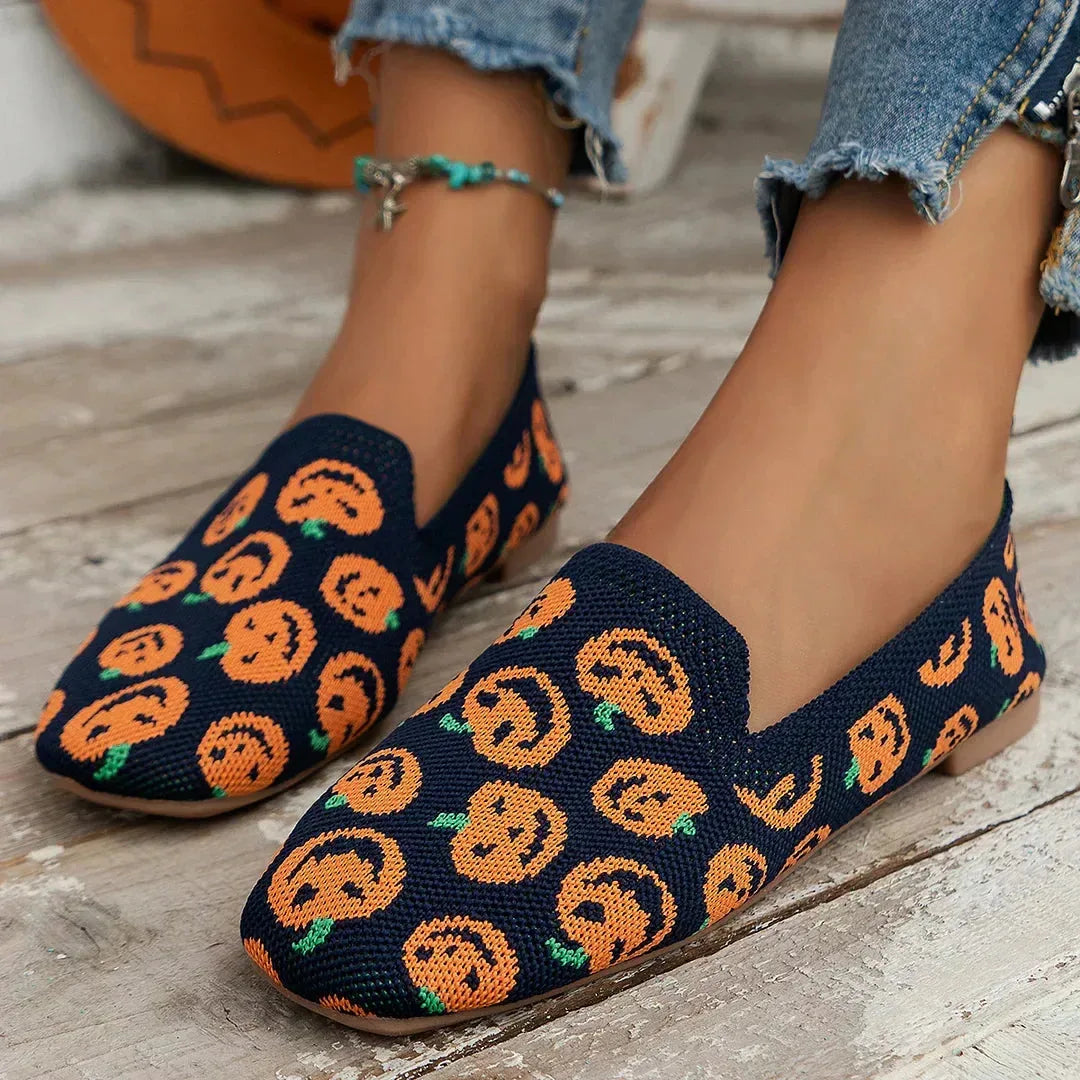 Pair of textured knit slip-on loafers arranged together showing stitched seam detailing