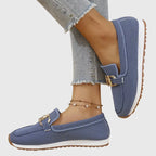 Pair of beige knit loafers shown from above resting on a plain light background