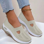 Top-down angle of grey knit slip-on shoes highlighting the diamond-textured upper, cut-out side panel and chunky white sole