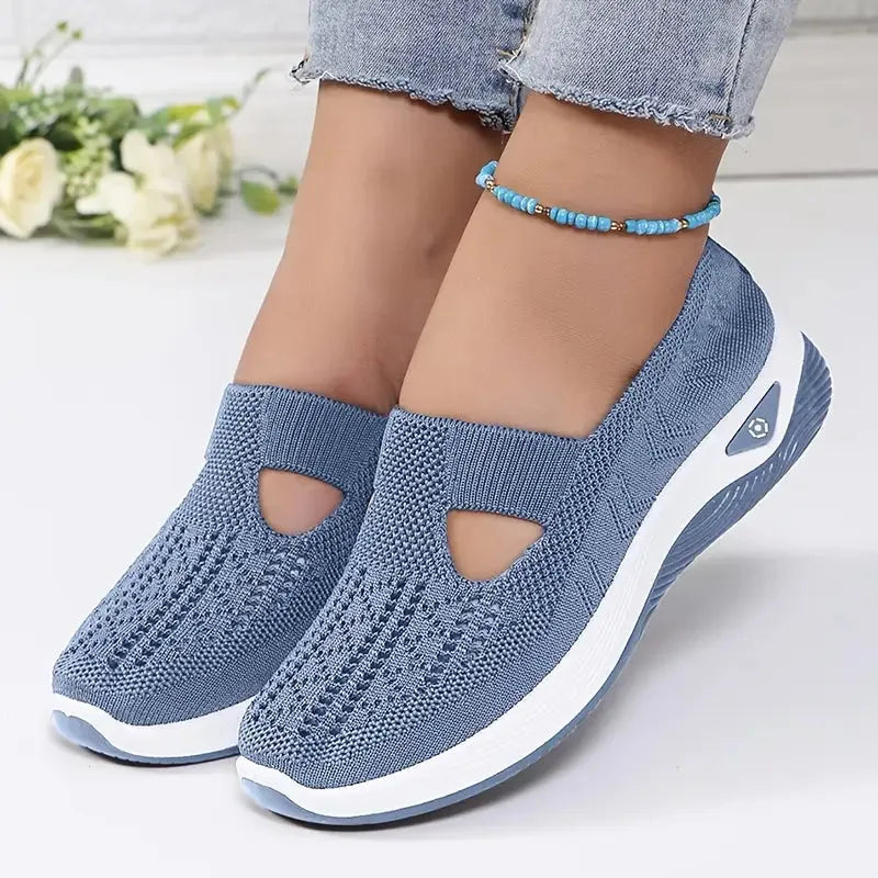 Detail shot focusing on the cushioned platform sole and logo tab on the knit slip-on shoe's outer side