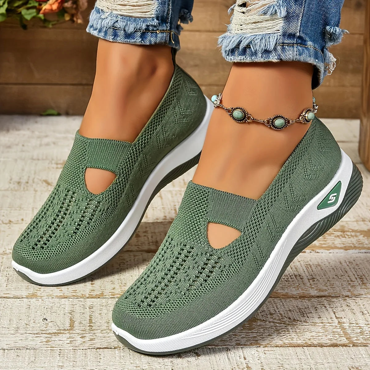 Pair of olive green knit slip-ons shown from the front, highlighting the woven diamond pattern and thick white platform sole