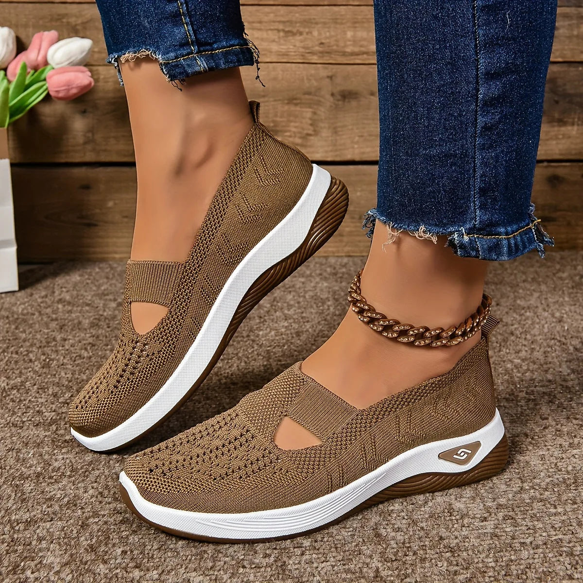 Close-up of brown knit slip-on shoes with woven texture, cut-out vamp and white-to-brown gradient platform sole