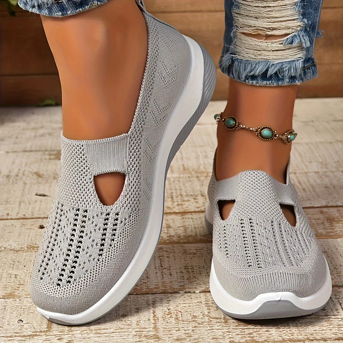 Top-down angle of a pair of knit slip-on shoes showing the diamond-stitch texture and soft cut-out panel on the instep