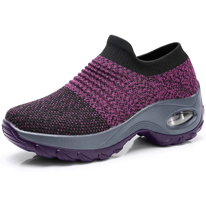 Navy blue knit sneaker with a white midsole, black outsole and ribbed ankle cuff