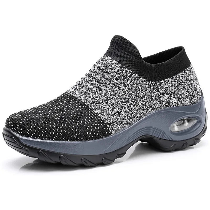 Black knit sneaker with a grey rubber sole and visible air cushion unit in the heel