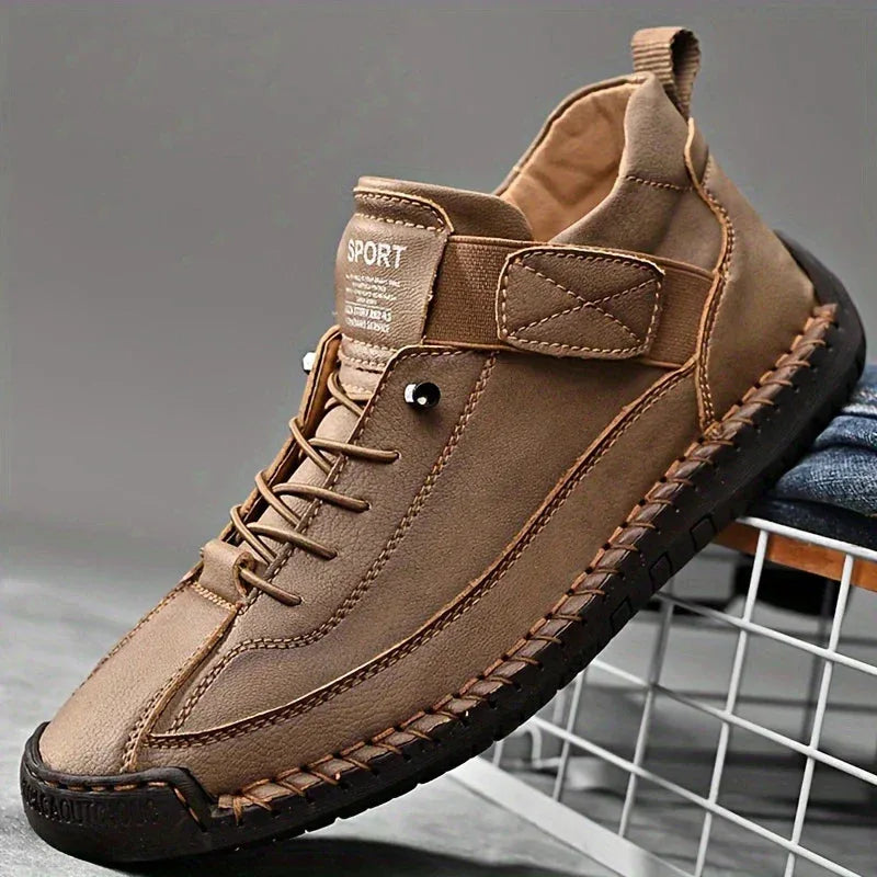 Rear angle of black leather sneaker showing padded collar and reinforced heel stitching