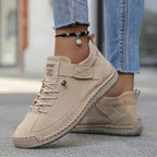 Taupe suede sneaker with black beaded anklet, showing elastic side panel and ribbed sole