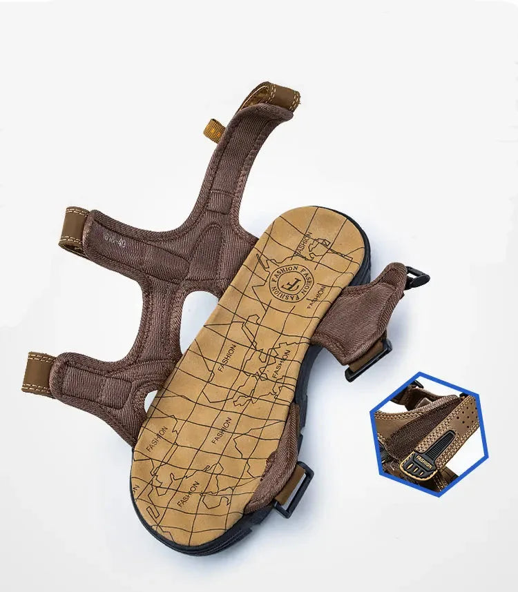 Underside view showing the tan map-print footbed, black cleated outsole and brown textile ankle strap laid flat.