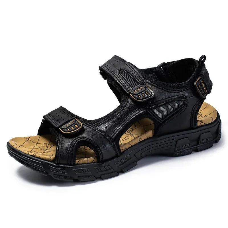 Side view of a black leather sandal with contrast stitching, two hook-and-loop straps and an open round toe.