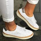 White perforated suede slip-on sneakers with metallic ankle panel and contrast stitched sole, front angle view