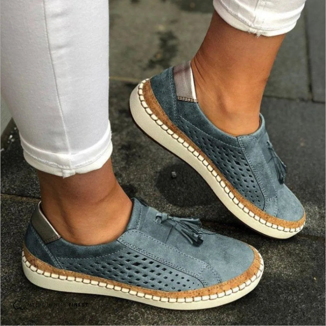 Dusty blue suede slip-on shoes with tassel lace and cork-wrapped sole, styled with cropped white trousers