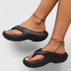 Close side angle of plain black chunky-sole thong sandal showing smooth rounded toe post
