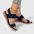 Close-up of pink and tan wedge sandal highlighting the braided platform sole and stretch straps