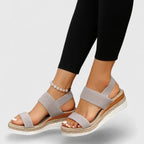 Pair of navy wedge sandals shown from above, highlighting the open toe and double strap design