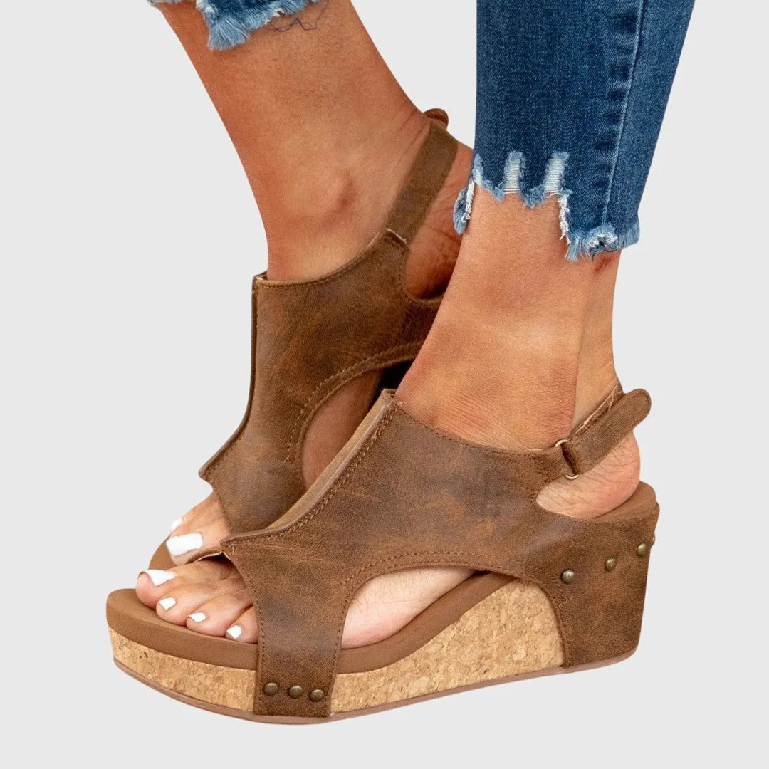 Top-down close-up of beige sandal showing open toe design and soft cushioned footbed