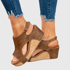 Close-up detail of cork wedge platform and stud trim on the beige sandal's heel cup