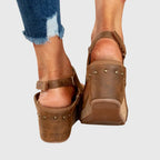 Styled front view of beige sandals paired with cuffed denim, showing overall silhouette and proportions