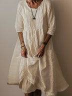Cream linen midi dress with front pocket detail and soft draped skirt