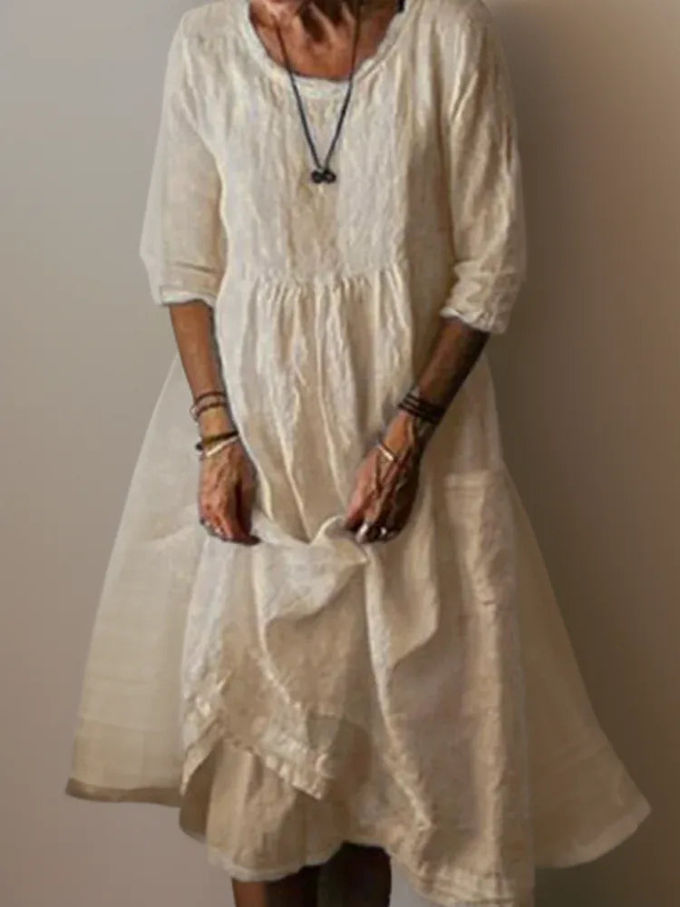 Cream linen midi dress with front pocket detail and soft draped skirt