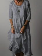 Pale grey linen midi dress with pleated bodice and tiered ruffled hemline