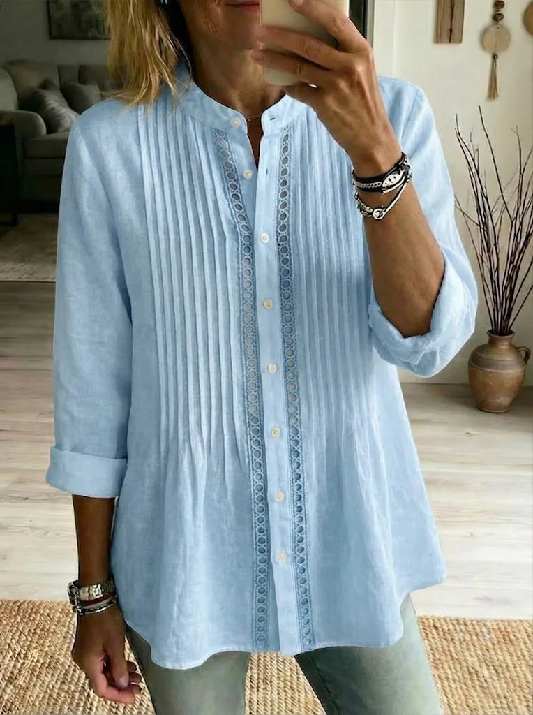 Light blue linen shirt with vertical pleats and crochet lace detail down the front, rolled-up sleeves shown.