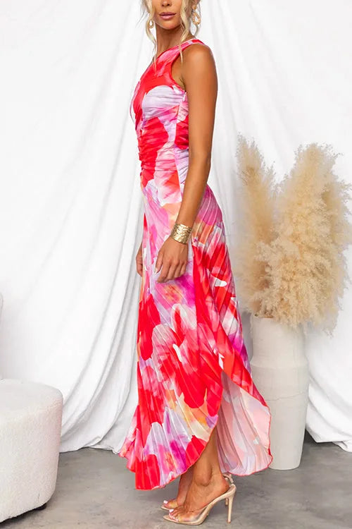 Side profile of the pleated maxi dress highlighting the ruched waist and flowing high-low hem