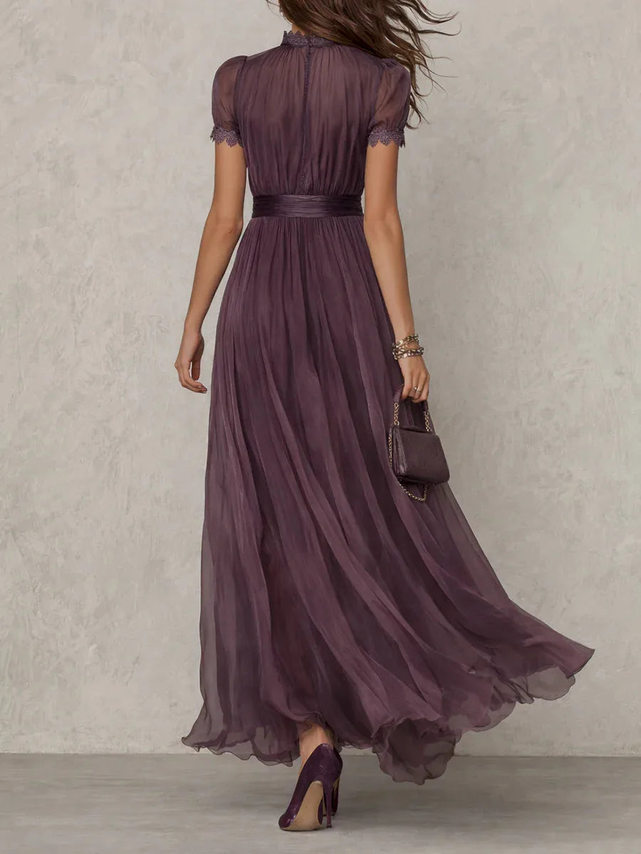 Back view of the plum maxi dress highlighting the high neckline, lace trim and flowing silhouette