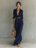 Navy blue wrap maxi dress with collared plunging neckline, long sleeves and draped front skirt detail