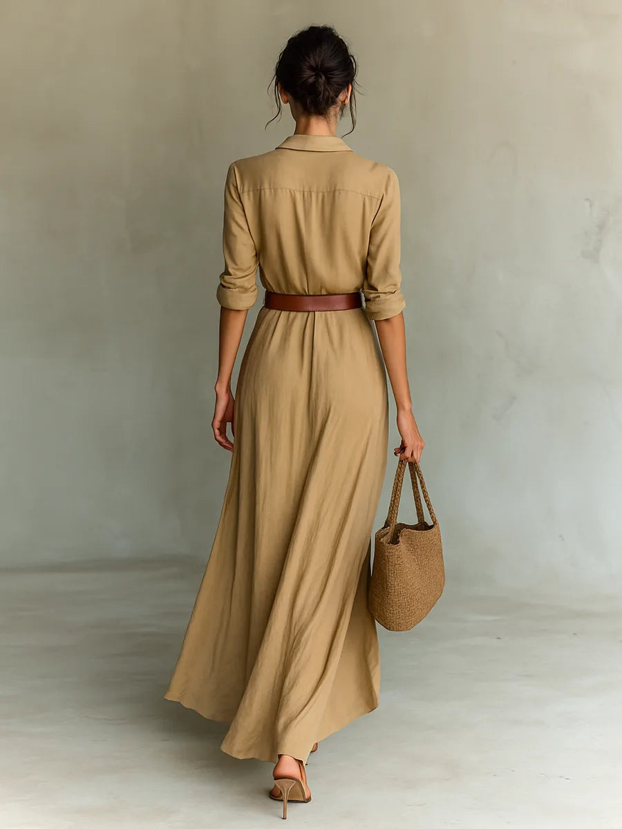 Back view of the beige wrap maxi dress showing the collared neckline, fitted waist and flowing skirt from behind