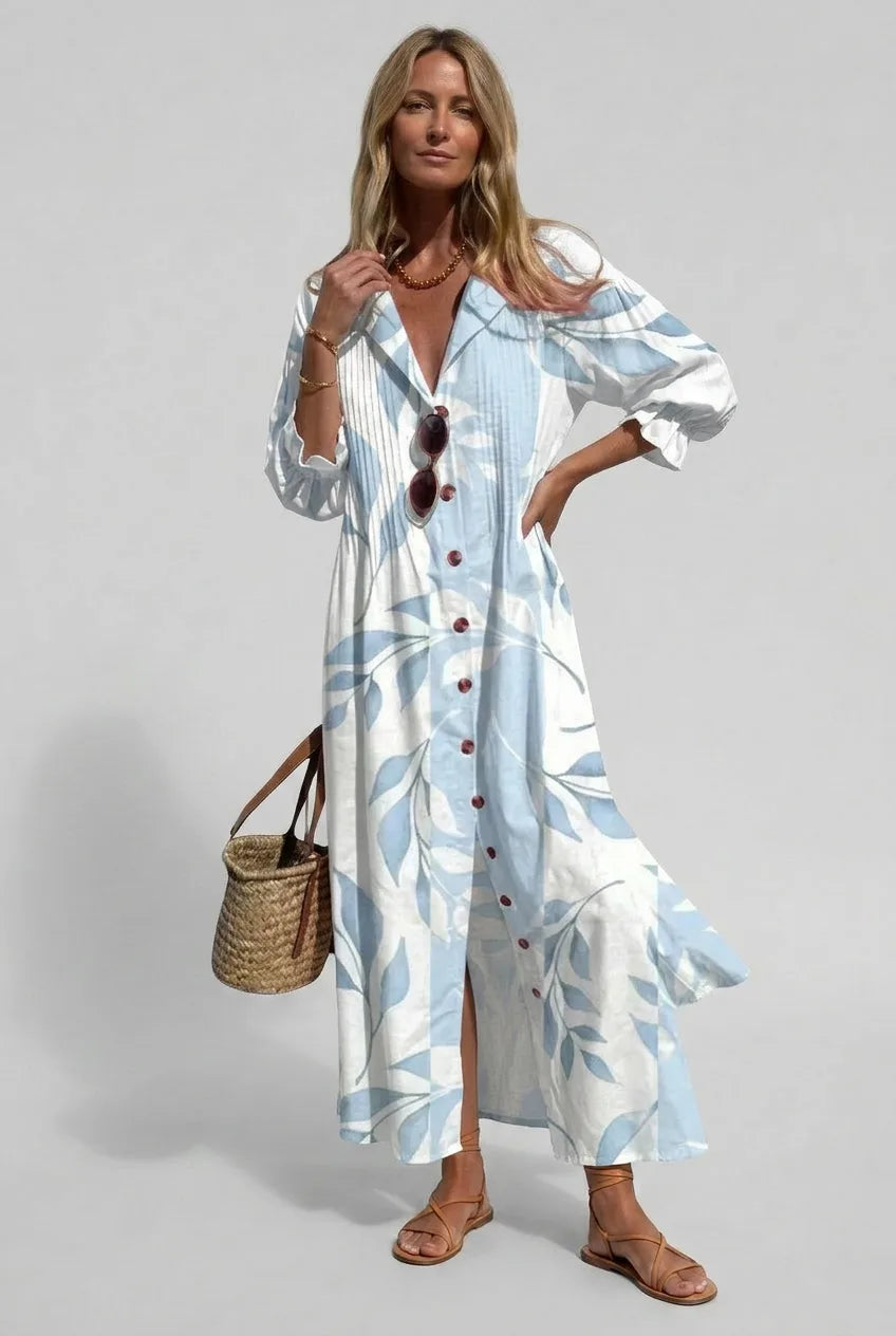Woman wearing a pale blue and white leaf print shirt dress with buttoned front and three-quarter sleeves