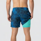 Back view of navy palm print swim shorts showing mint compression liner and rear pocket detail