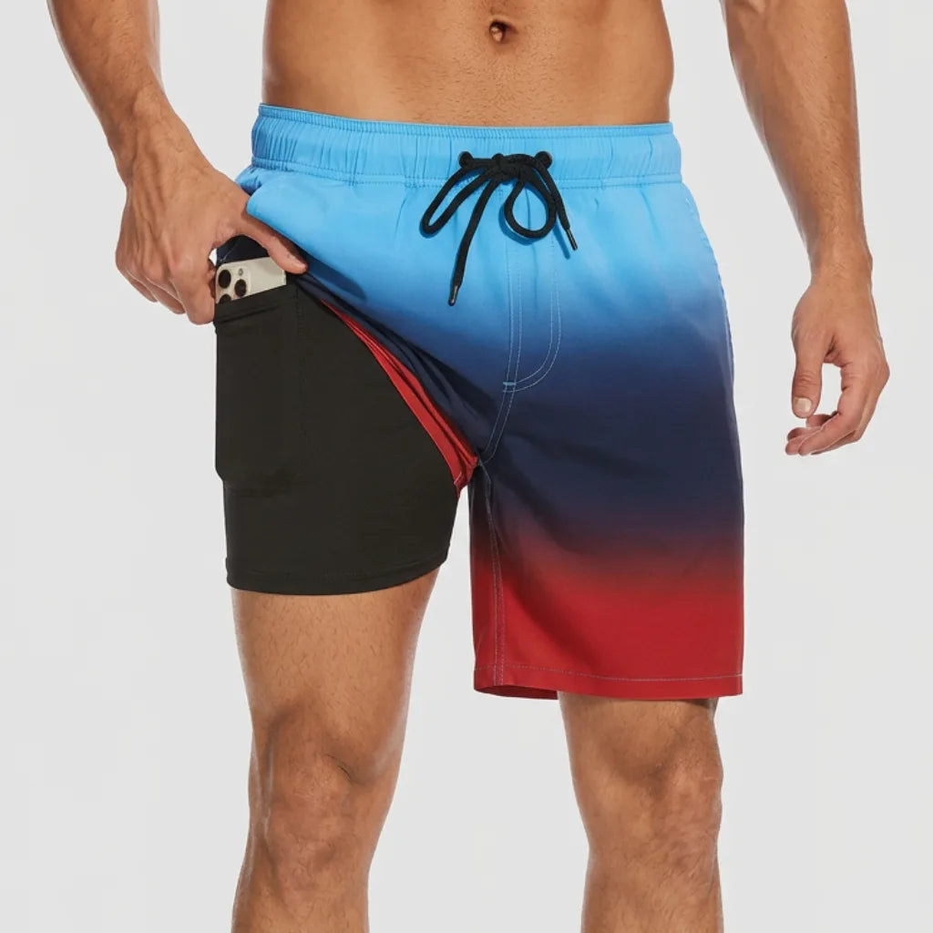 Front view of ombre blue-to-red swim shorts with pocket open revealing black compression liner holding a phone