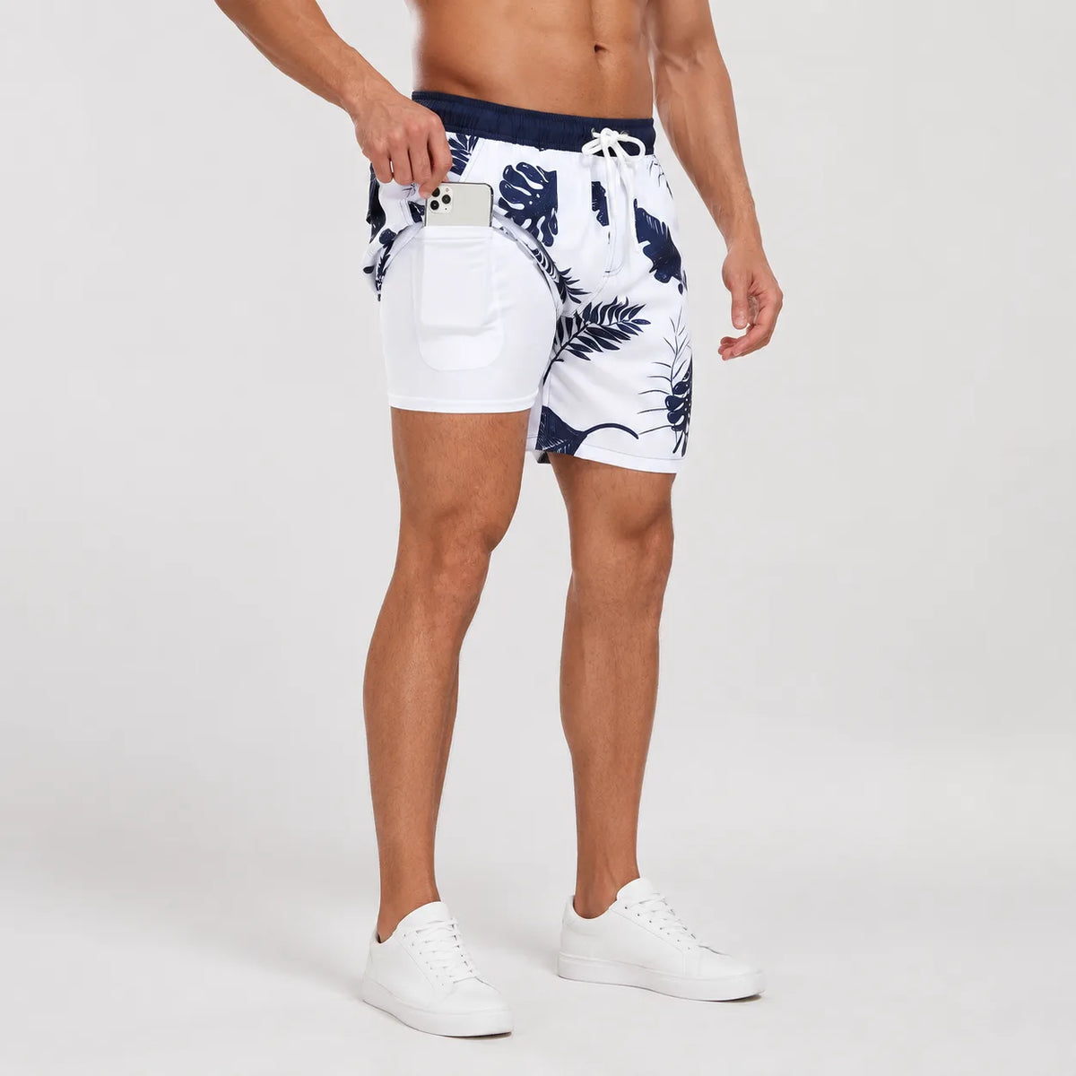 Side view showing the layered construction of swim shorts with compression liner extending below the outer layer