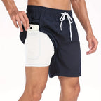 Close-up of navy swim shorts with white drawstring and built-in compression liner showing phone pocket detail