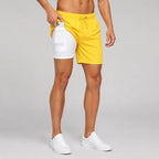 Man wearing navy swim shorts and white sneakers, full side view showing relaxed fit and length
