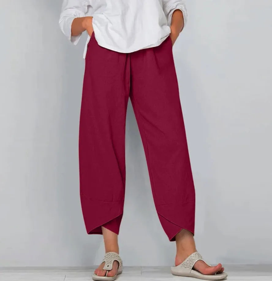 Front view of deep red linen-blend pants showing the elastic waistband and flowing ankle-length cut
