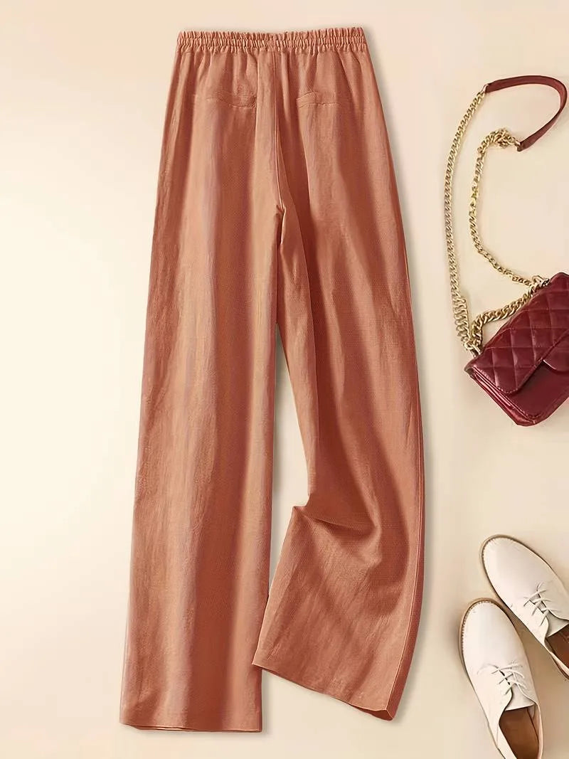 Back view of terracotta linen pants showing back pockets, elastic waistband and wide straight leg